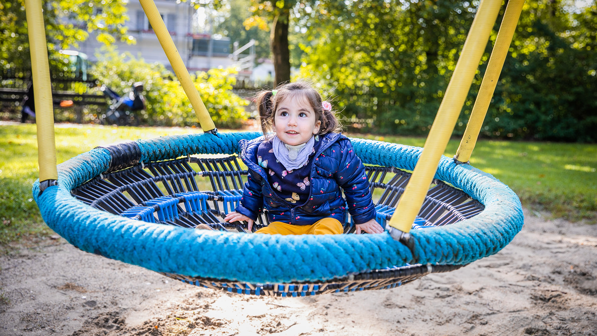 little girl with a tracheostomy on a swing