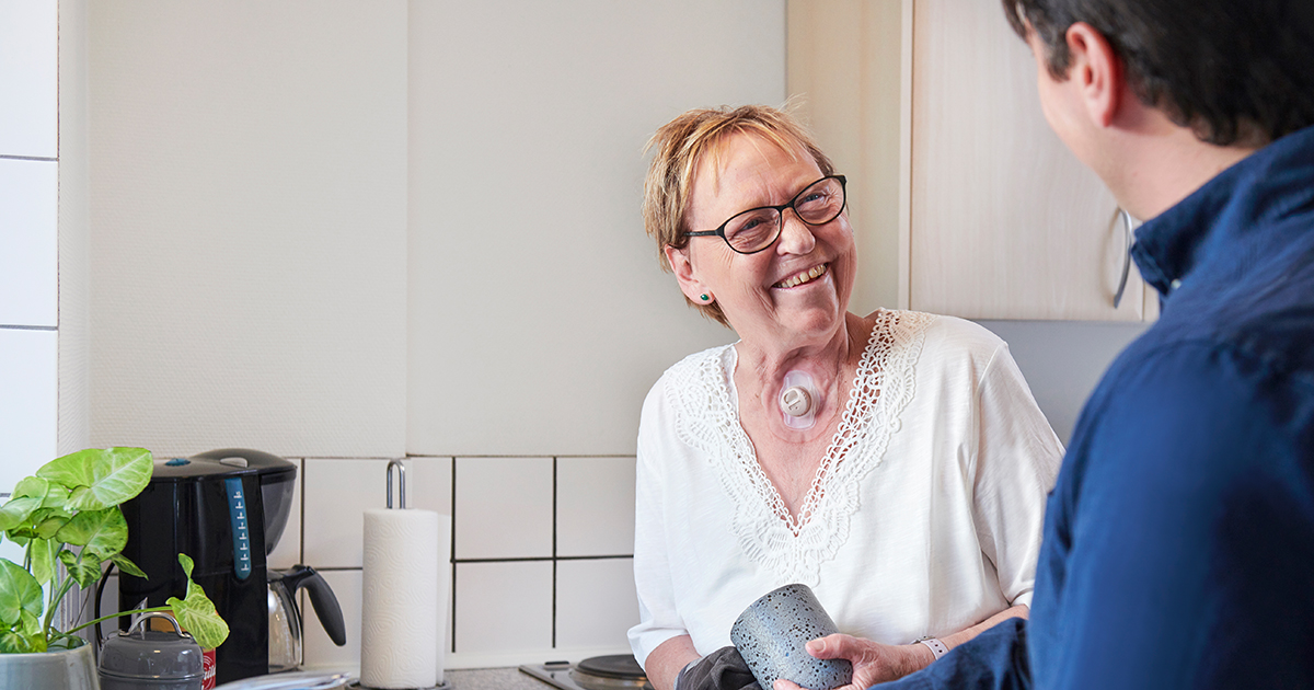 laryngectomy patient washing dishes