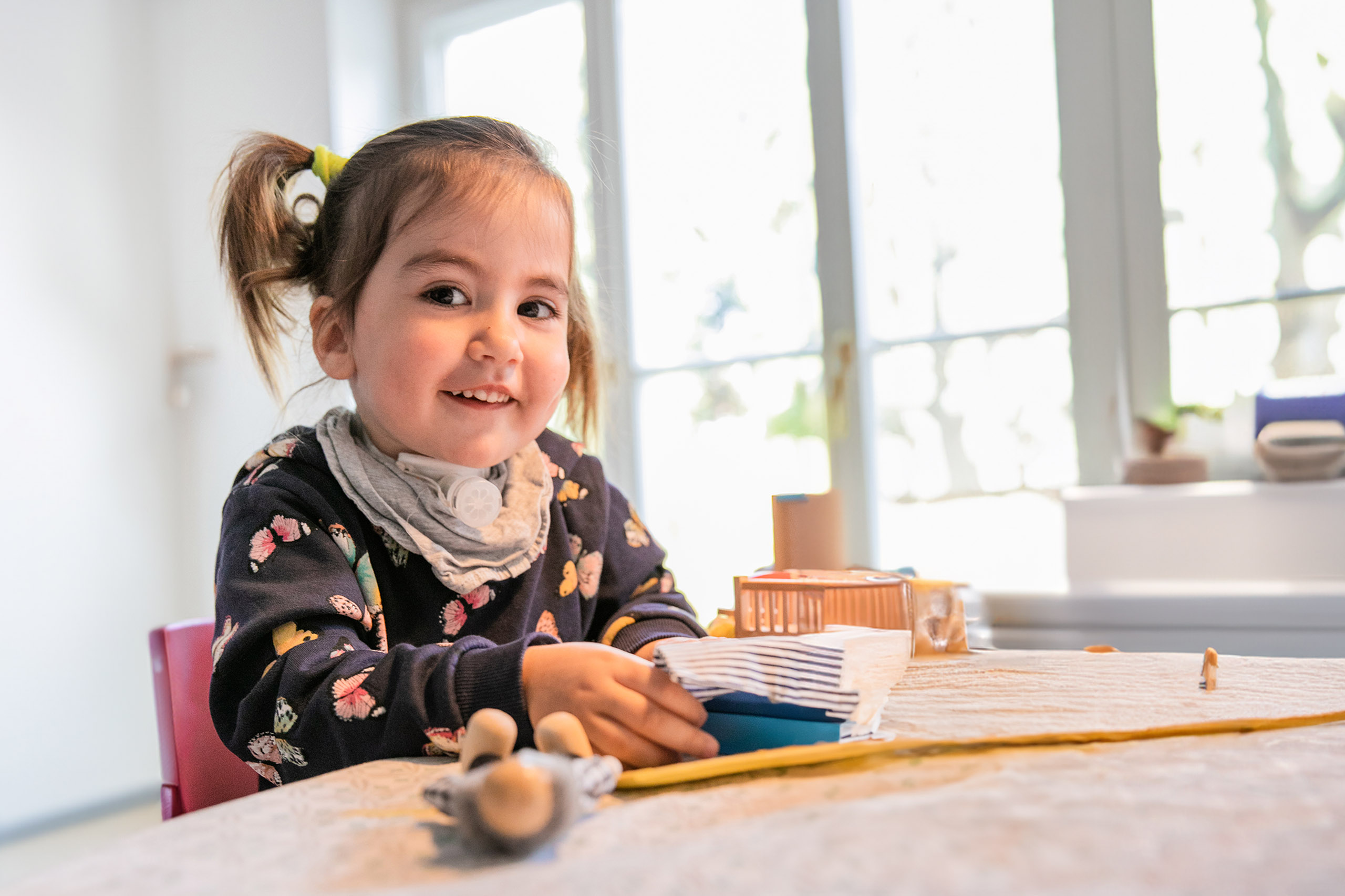 little-girl-with-a-tracheostomy-wearing-tracoe-phonassist-playing